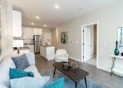 Thumbnail 46 of 80 - A modern living room with a white couch and a black coffee table at The Barnum Apartments, Minnesota, 55110