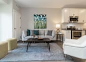 Thumbnail 47 of 80 - A living room with a couch, chair, and coffee table at The Barnum Apartments, Minnesota, 55110