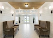 Thumbnail 4 of 80 - Brown sofa with white door at The Barnum Apartments, Minnesota, 55110