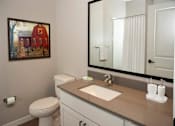 Thumbnail 71 of 80 - Bathroom with large mirror and sink at The Barnum Apartments, White Bear Lake, MN,  55110
