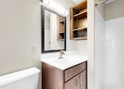 Thumbnail 9 of 28 - A white sink with a gold faucet and a mirror above it.