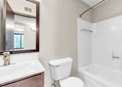 Thumbnail 8 of 28 - A white toilet sits next to a sink in a bathroom.
