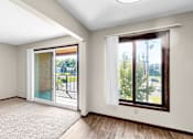 Thumbnail 3 of 28 - A room with a sliding glass door leading to a balcony.