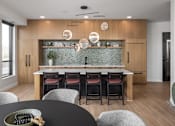 Thumbnail 5 of 92 - A modern kitchen with a dining table set for four.