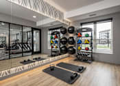 Thumbnail 22 of 92 - A well-equipped home gym with a variety of exercise equipment.
