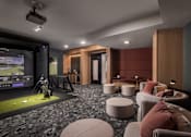 Thumbnail 19 of 92 - A room with a golf simulator and seating area.