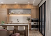 Thumbnail 16 of 92 - A modern kitchen with a wooden cabinet and a marble backsplash.