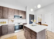 Thumbnail 45 of 92 - A modern kitchen with a white island and wooden cabinets.