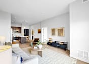 Thumbnail 50 of 92 - A modern living room with a white sofa and a coffee table.