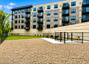 Thumbnail 59 of 110 - A large building with a fenced in yard in front.