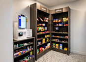 Thumbnail 76 of 110 - A modern vending machine is located in a room with a black and white checkered floor.