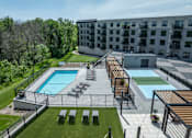 Thumbnail 1 of 92 - A large outdoor pool area with sun loungers and a wooden deck.