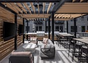Thumbnail 91 of 92 - A patio with a table and chairs under a roof.