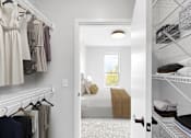 Thumbnail 83 of 92 - A white closet with clothes hanging and a doorway leading to a bedroom.