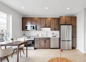 Thumbnail 110 of 110 - A modern kitchen with wooden cabinets and stainless steel appliances.