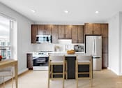 Thumbnail 72 of 92 - A modern kitchen with wooden cabinets and stainless steel appliances.