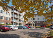 Thumbnail 1 of 31 - Osceola Place exterior of community with pretty fall colors on trees
