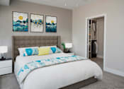 Thumbnail 24 of 64 - A bedroom with a large bed and two paintings on the wall.