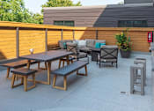 Thumbnail 45 of 64 - A wooden table and benches are set up on a patio.