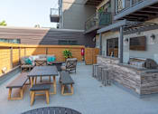 Thumbnail 46 of 64 - A patio with a bar and seating area.
