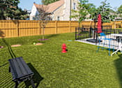 Thumbnail 48 of 64 - A backyard with a black bench and a red fire hydrant.