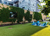 Thumbnail 49 of 64 - A building with a green vine on the side.