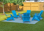 Thumbnail 52 of 64 - A set of blue lawn furniture is arranged on a green lawn.