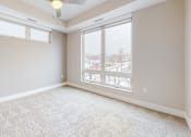 Thumbnail 19 of 64 - A room with a carpeted floor and a ceiling fan.