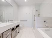 Thumbnail 17 of 64 - A white bathroom with a walk in shower.