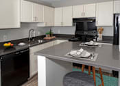 Thumbnail 28 of 83 - Granite Counter Tops In Kitchen at Audenn Apartments, Bloomington, MN
