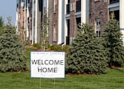Thumbnail 3 of 81 - A row of houses with a sign that says Welcome Home.