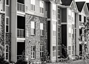 Thumbnail 4 of 81 - A black and white image of a row of townhouses.