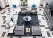 Thumbnail 9 of 81 - A black and white tiled floor with a coffee table and grey couches.