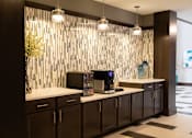 Thumbnail 10 of 81 - A modern kitchen with dark brown cabinets and a white countertop.