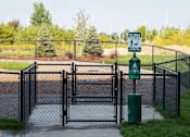 Thumbnail 20 of 81 - A sign on a post in front of a fence indicates a pet waste area.