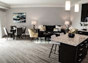 Thumbnail 24 of 81 - A modern living room with a grey carpet and a black and white sofa.