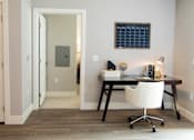 Thumbnail 30 of 81 - A white chair is in front of a desk with a black frame.
