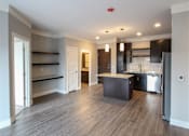 Thumbnail 33 of 81 - A kitchen with a refrigerator, sink, and cabinets.
