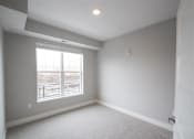 Thumbnail 35 of 81 - A room with a carpeted floor and a window.