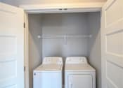 Thumbnail 37 of 81 - A small laundry room with a washer and dryer.