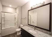Thumbnail 38 of 81 - A bathroom with a sink, toilet, and shower.