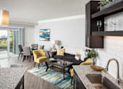 Thumbnail 47 of 81 - A modern kitchen with a dining area and a view of the outdoors.