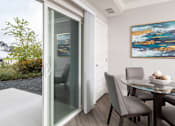 Thumbnail 53 of 81 - A modern dining room with a glass table and chairs.