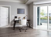 Thumbnail 54 of 81 - A room with a desk and a chair in it.