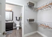 Thumbnail 57 of 81 - A bathroom with a toilet, sink, and clothes hangers.