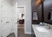 Thumbnail 60 of 81 - A bathroom with a white sink and a mirror.