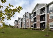 Thumbnail 80 of 81 - Apartment building with balconies and a green lawn in front.