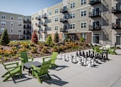 Thumbnail 6 of 32 - A chess set is set up on a patio at The Edison at Rice Creek I and II, Shoreview, 55126