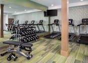 Thumbnail 30 of 32 - A gym with treadmills, exercise bikes, and weights.at The Edison at Rice Creek I and II, Shoreview, MN