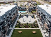 Thumbnail 26 of 47 - A view of a courtyard with a pool and apartment buildings at The Edison at Spirit, Minnesota